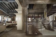 a living room filled with furniture and a spiral staircase