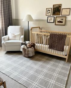 a baby's room with a crib, chair and teddy bear