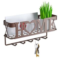 a couple of keys hanging from a metal holder with the word home written on it