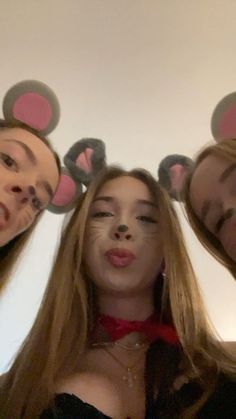 three people with mouse ears on their heads