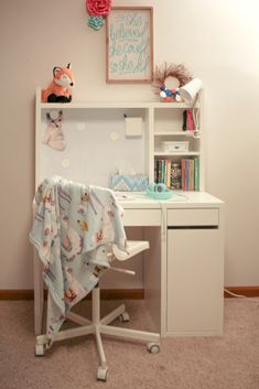 a child's desk with a blanket on it