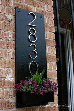 a sign on the side of a brick building that says cococo with flowers in it