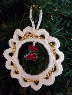 a crocheted ornament hanging from a christmas tree