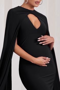 Opt for opulence at your next black tie event in Standing Ovation. This enchanting black maternity maxi dress was designed in our signature stretch jersey that hugs each curve and effortlessly accentuates your frame. Defined by extravagant cape sleeves. keep Standing Ovation at the forefront by styling it with a tousled bun and strappy stilettos. Features - Premium stretch jersey - Plunge neckline- Cape sleeves- Knot detail- Open back- Invisible zip closure - Fishtail skirt- Maxi length Sizing & Black Maternity Maxi Dress, Club L London, Maternity Maxi Dress, Wedding Shoes Bride, Standing Ovation, Black Dress Prom, Fishtail Skirt, Strappy Stilettos, Black Tie Gala