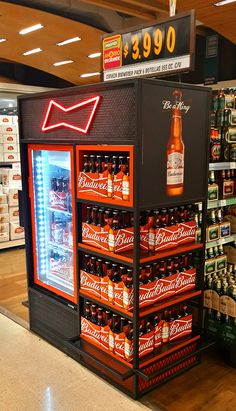 a display in a grocery store filled with lots of beer bottles and cans on the shelves