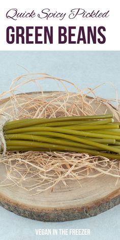 some green beans are sitting on top of a piece of wood