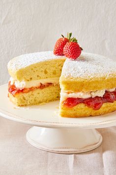 a strawberry shortcake on a white cake plate