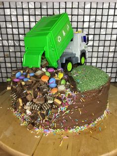 a birthday cake that looks like a garbage truck with sprinkles on it