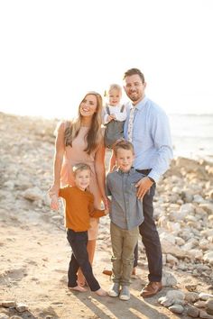 a family posing for a photo on the beach