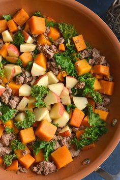 a bowl filled with meat and vegetables on top of a table