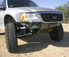 a white pick up truck parked in the desert