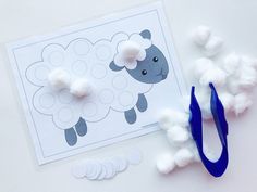 the craft kit includes cotton balls and scissors to make a sheep cut out from paper