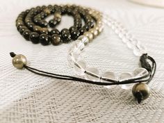 The Ultimate Wealth Protection 108 Mala is meticulously designed to attract and safeguard wealth while providing grounding, protection, and clarity. Featuring a powerful combination of Clear Quartz, Black Obsidian, and Pyrite. Crystal Breakdown: Clear Quartz amplifies energy, enhances clarity, balances and harmonizes energies, and boosts the properties of other crystals. Feng Shui Element: Metal Life Path Number: 1, 4, 7 Black Obsidian provides protection, grounding, and clarity; removes negativ Spiritual Jewelry With 108 Beads For Everyday, Everyday Spiritual Jewelry With 108 Beads, Feng Shui Elements, Wrist Mala, Life Path Number, Removing Negative Energy, Pyrite Crystal, Mala Necklace, Black Obsidian