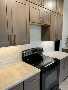 a black stove top oven sitting inside of a kitchen