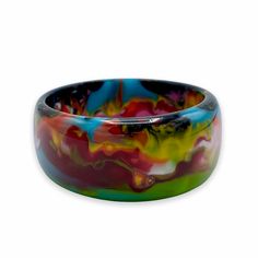 Chunky bangle bracelet with colorful marbled design 2.5"D Made from colored resin Note: Each piece is handmade and one-of-a-kind. Patterns and coloring will vary Free shipping! Designed in South Florida and made in Brazil. Multicolor Hand Painted Bangle Bracelets, Multicolor Hand Painted Bangle Jewelry, Multicolor Hand Painted Bangle Bracelet, Hand Painted Multicolor Bangle Jewelry, Hand Painted Multicolor Bangle Bracelet, Multicolor Hand Painted Bangle, Hand Painted Multicolor Bangle, Artistic Multicolor Bangle Bracelet, Handmade Multicolor Resin Bracelets