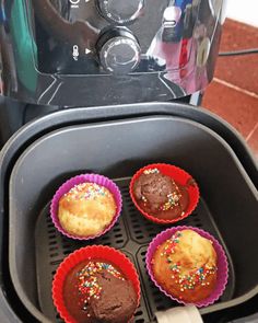 four cupcakes are being cooked in the air fryer