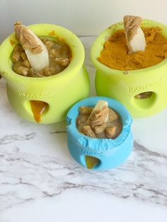 three bowls filled with food sitting on top of a marble counter next to each other