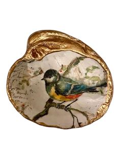 Bring a touch of nature-inspired beauty to your home with this stunning bird design decoupage clam shell trinket dish/jewelry holder. The delicate and intricate bird motif adds a whimsical and elegant touch to this unique piece. Use it to store your favorite jewelry pieces or small trinkets, adding a touch of charm and sophistication to your vanity or bedside table. This clam shell dish is not only functional but also a stylish decorative piece that will elevate any space with its natural and timeless beauty. Perfect gift for bird lovers or anyone who appreciates the beauty of nature, this trinket dish is a must-have addition to your home decor collection. The backs of the shells are natural, colors vary.  They are finished with baby oil to enhance colors and add a shine.  Shells vary in c Decoupage Jewelry, Shell Trinket Dish, Small Trinkets, Bird Motif, Clam Shell, Baby Oil, Gift For Mother