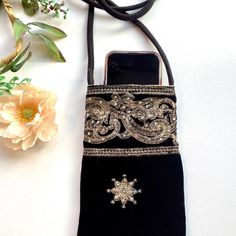 This beautiful handcrafted crossbody bag features striking pale gold embroidery and is decorated with rhinestones. The pattern includes embroidered leaf and flower design on a soft black velvet bag. The bag is the perfect size for keeping your mobile cell phone and credit cards, keys and lip gloss and will set your outfit apart from the crowd perfectly! The bag is fashionable, elegant and practical and is beautifully made. A stunning addition to any outfit for a really fun and unique touch.  The Shoulder Sling Bag, Embroidered Leaf, Stylish Iphone Cases, Embroidered Leaves, Shoulder Sling, Gold Embroidery, Pale Gold, Velvet Bag, Bag Handmade