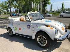 a white car with flowers painted on the side