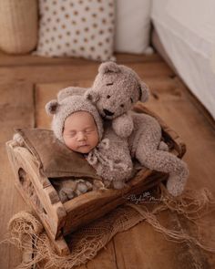 a baby is sleeping in a basket with a teddy bear on it's back