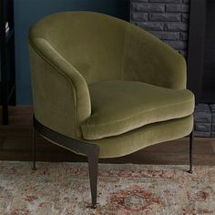 a green chair sitting on top of a rug