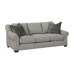 a gray couch with two pillows on it's back and one arm facing the camera