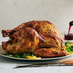 a roasted turkey on a plate with garnishes