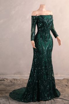 a green evening gown with sequins on the shoulders and off the shoulder neckline