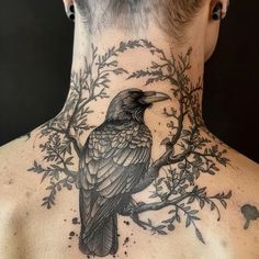 the back of a man's neck with a bird on it