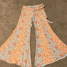 Free People Bell Bottom Pants Flat Front/Elastic Back/ Tie Sash Around Waist Size Small Bought At A Free People Rack Sale Brand New, Never Worn Fitted Floral Print Pants For The Beach, Multicolor Vacation Bottoms With Tie Waist, Multicolor Tie Waist Bottoms For Spring, Multicolor Bottoms With Tie Waist For Spring, Orange Cotton Pants For Vacation, Fitted Blue Bottoms With Tie Waist, Spring Multicolor Bottoms With Tie Waist, Bohemian Orange Bottoms With Elastic Waistband, Orange Hippie Bottoms For Spring