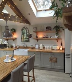 a kitchen filled with lots of counter space next to a wooden dining table and chairs