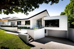 a modern house with white walls and windows