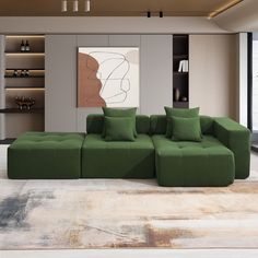 a large green couch sitting in the middle of a living room