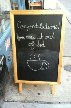 a chalkboard sign with writing on it that says congratulations you made it out of bed