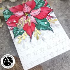 a card with poinsettis and the word joy on it