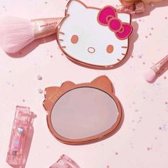 hello kitty makeup and mirror on pink background