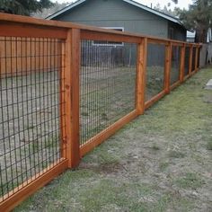 the fence is made of wood and has metal bars on each side, along with grass