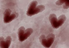 some red hearts are in the air on a pink background with black spots and white clouds