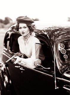 a woman sitting in the driver's seat of a car