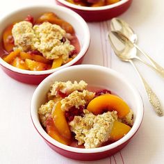 three bowls filled with fruit and crumbled toppings on top of a table