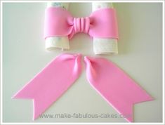 a pink ribbon and two rolls of toilet paper