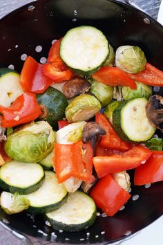 a skillet filled with vegetables on top of a table