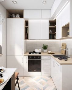 an image of a kitchen setting with white cabinets and wood flooring on the walls