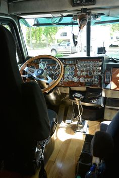 the interior of an airplane with wood flooring and leather seats, including steering wheel