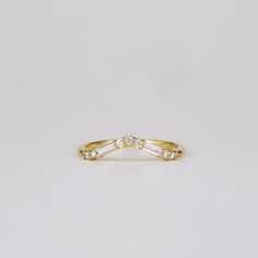 a yellow gold ring with three baguettes in the middle and two diamonds on each side