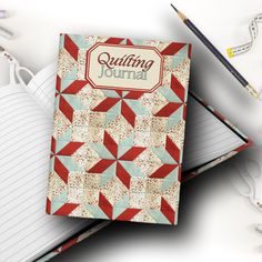 an open notebook with the words quilting journal written on it