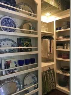 an open pantry with plates and bowls on the shelves, dishes are sitting on top of each other