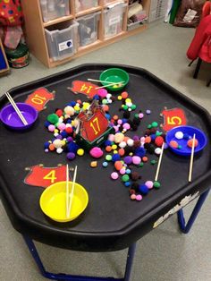 a black table topped with lots of candy and cupcakes on top of it