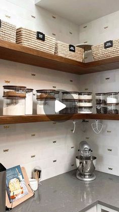 a kitchen with lots of shelves and baskets on top of the countertop next to a coffee maker